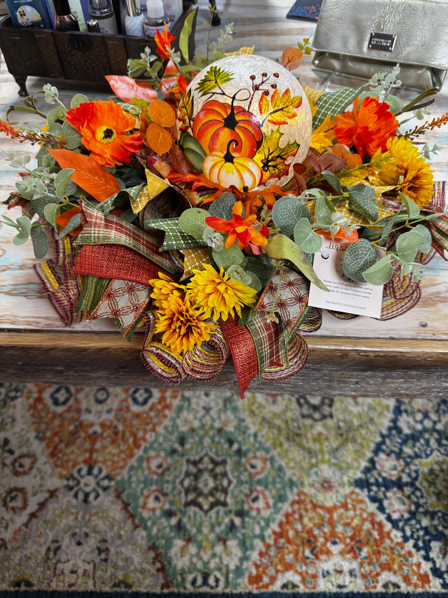 Handmade Pumpkin Glow Fall Centerpiece with crackle-glass pumpkin globe, sunflowers, mums, eucalyptus & plaid ribbons. Perfect for tables, mantels & fall gatherings.