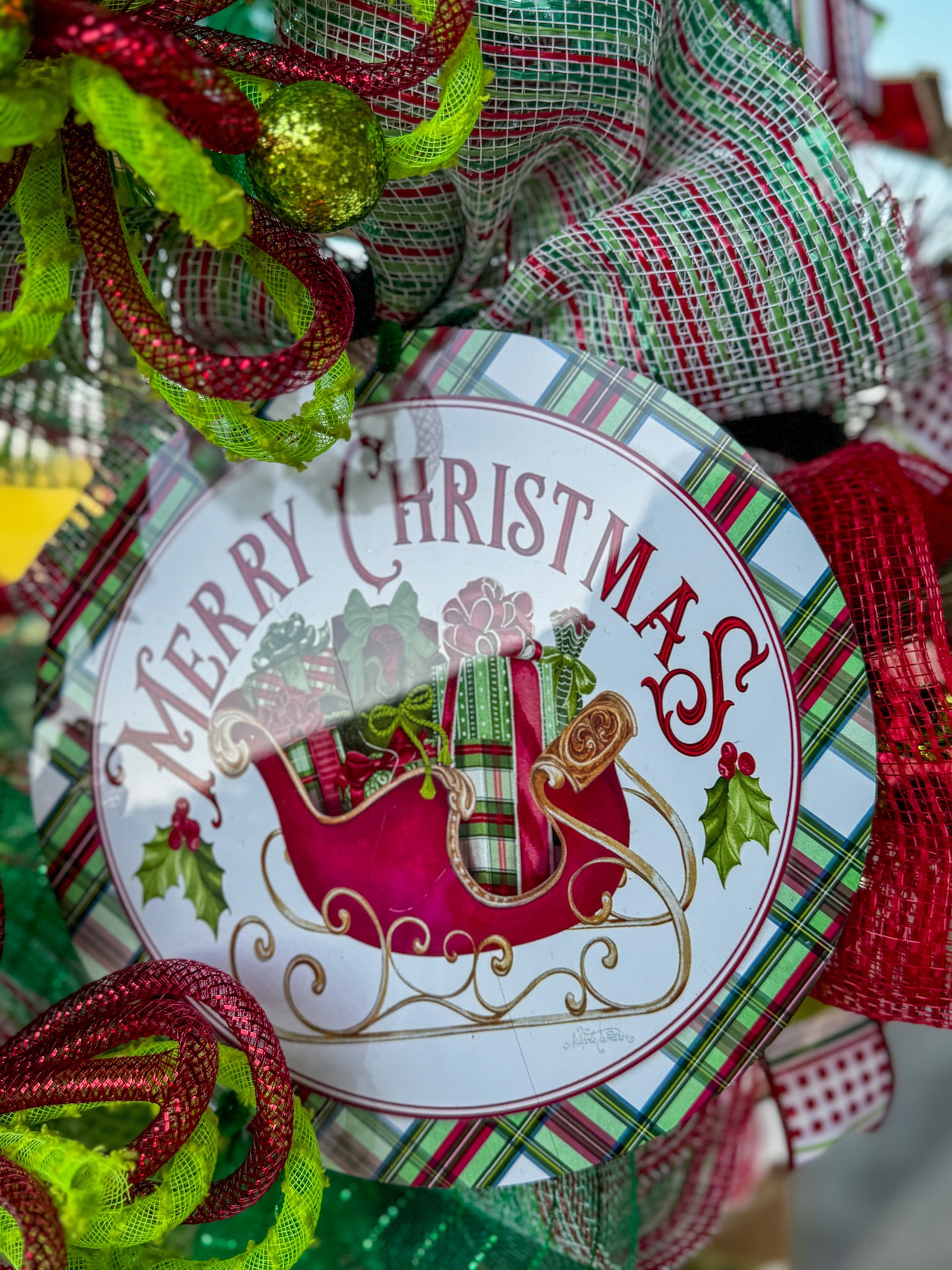 A burst of Christmas cheer! This Peppermint Twist Wreath blends playful red, green, and white ribbons with sparkling ornaments and a festive “Merry Christmas” sign — handcrafted to bring joy and color to your holiday door