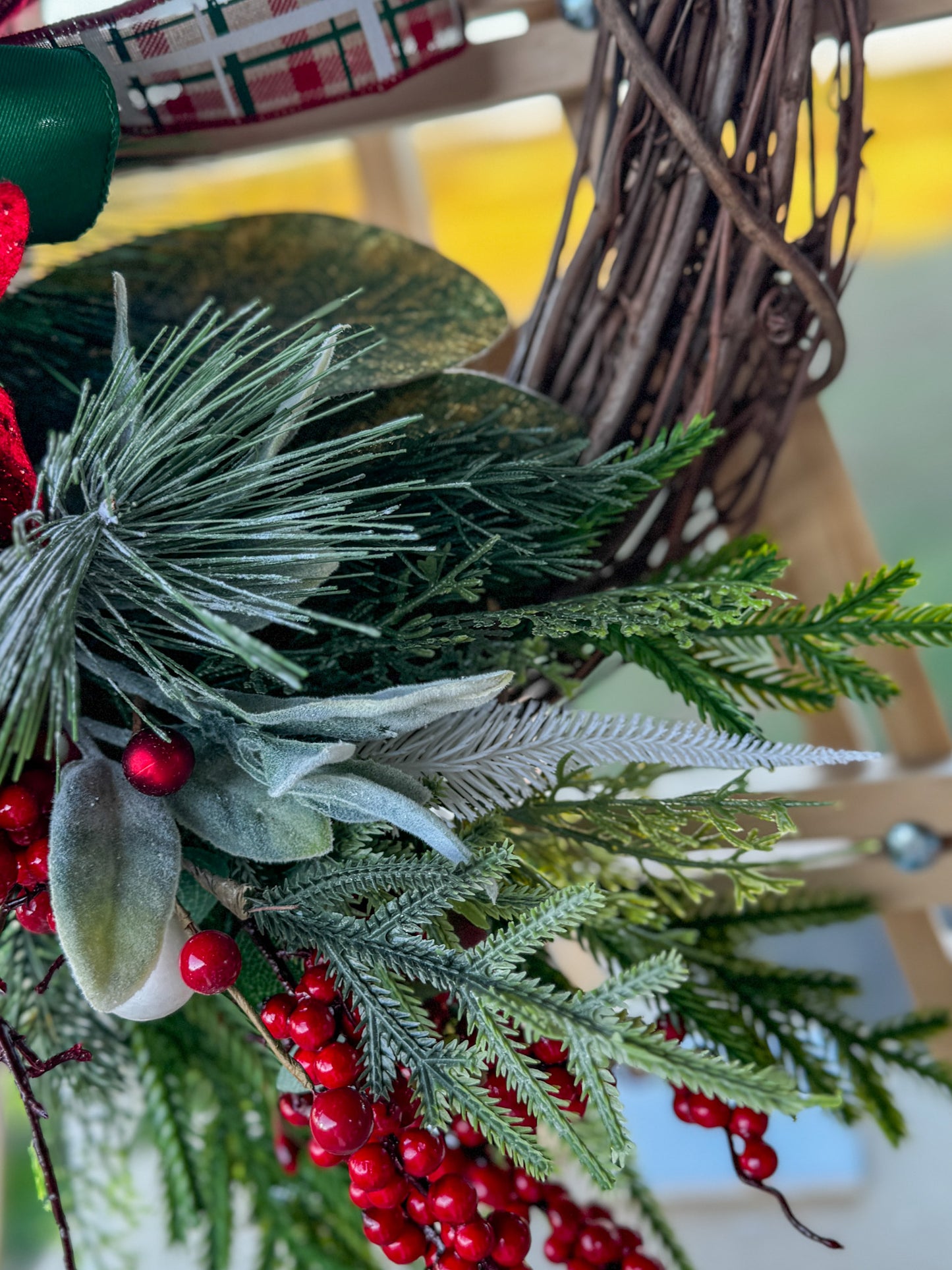 Two Poinsettia Christmas Grapevine Wreath:  Traditional Christmas beauty with a touch of handcrafted grace — this Two Poinsettia Grapevine Wreath features vibrant red poinsettias, lush greenery, and layered plaid ribbons in rich holiday tones.