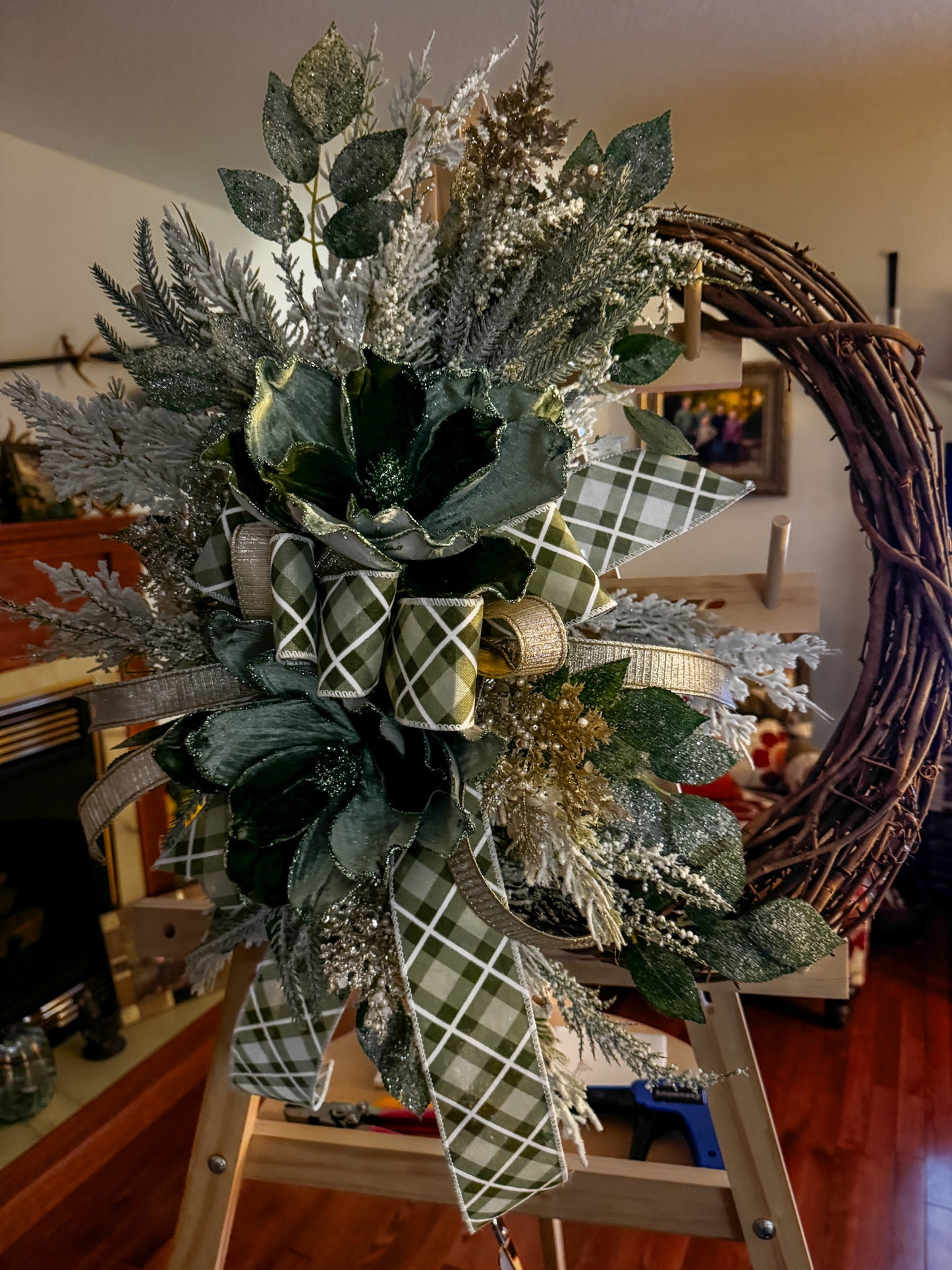 Winter Green Magnolia Grapevine Wreath with Jeweled Picks & Farrisilk Ribbon Short Description  Elegant, serene, and timeless — this handcrafted winter green magnolia wreath combines frosted greenery, jeweled accents, and luxurious Farrisilk ribbon.