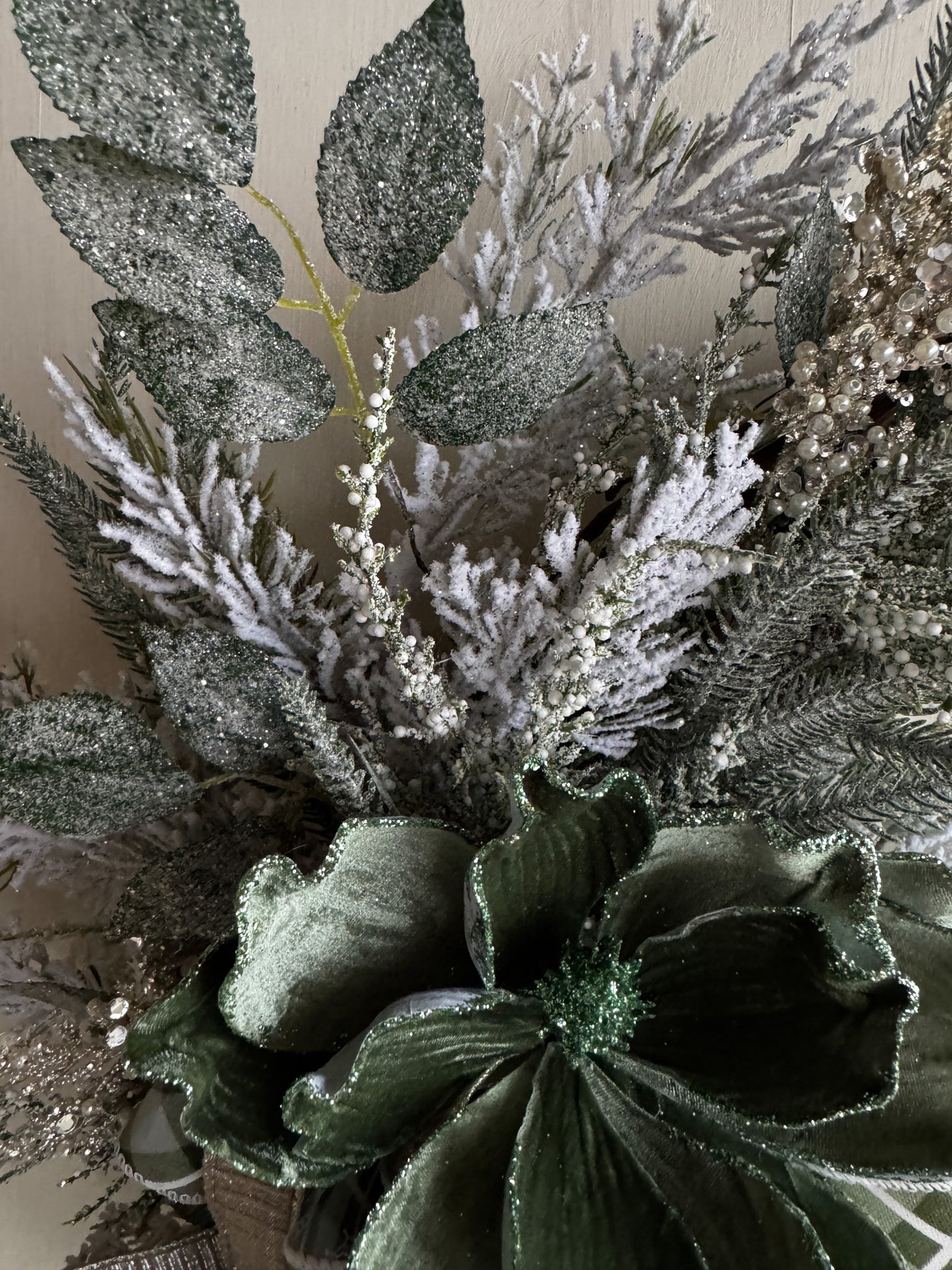Winter Green Magnolia Grapevine Wreath with Jeweled Picks & Farrisilk Ribbon Short Description  Elegant, serene, and timeless — this handcrafted winter green magnolia wreath combines frosted greenery, jeweled accents, and luxurious Farrisilk ribbon.