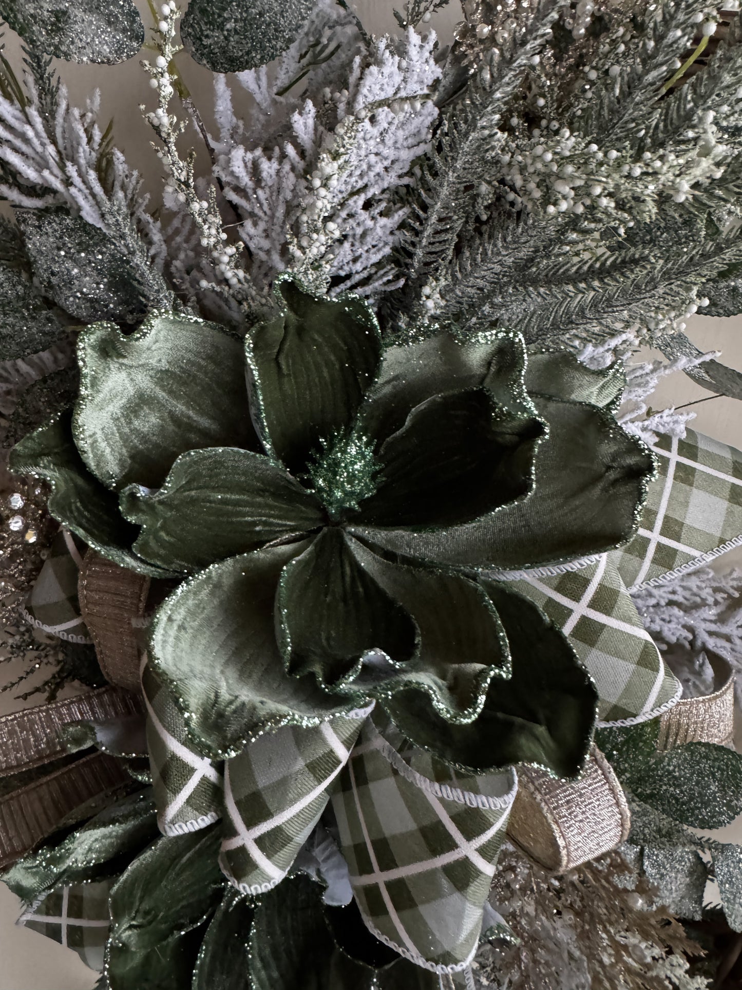 Winter Green Magnolia Grapevine Wreath with Jeweled Picks & Farrisilk Ribbon Short Description  Elegant, serene, and timeless — this handcrafted winter green magnolia wreath combines frosted greenery, jeweled accents, and luxurious Farrisilk ribbon.