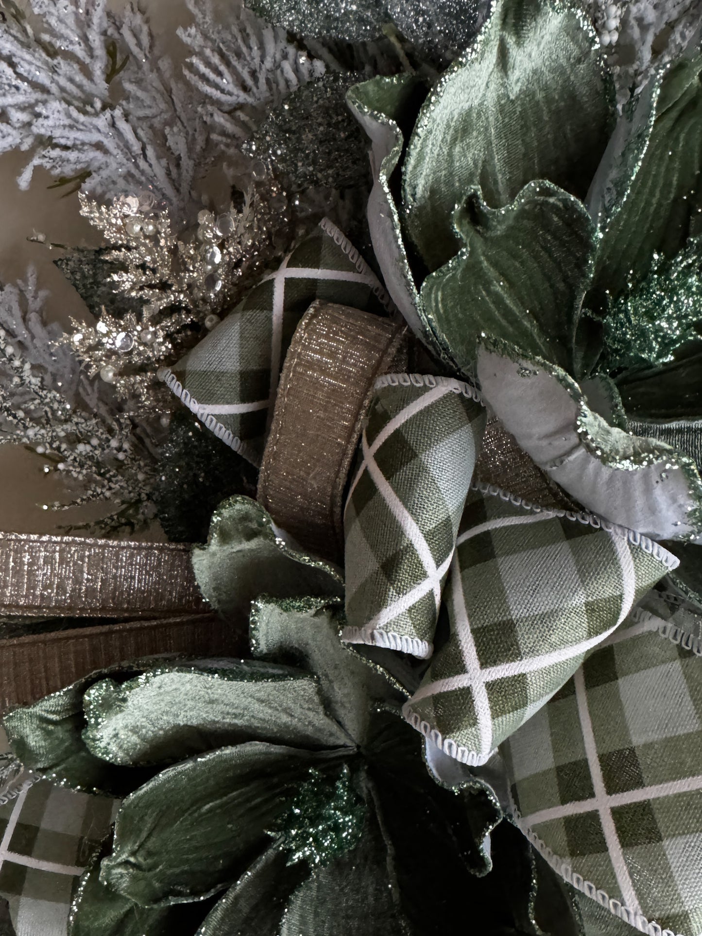 Winter Green Magnolia Grapevine Wreath with Jeweled Picks & Farrisilk Ribbon Short Description  Elegant, serene, and timeless — this handcrafted winter green magnolia wreath combines frosted greenery, jeweled accents, and luxurious Farrisilk ribbon.