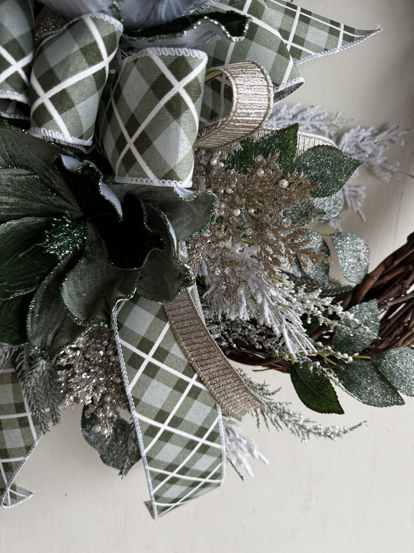 Winter Green Magnolia Grapevine Wreath with Jeweled Picks & Farrisilk Ribbon Short Description  Elegant, serene, and timeless — this handcrafted winter green magnolia wreath combines frosted greenery, jeweled accents, and luxurious Farrisilk ribbon.