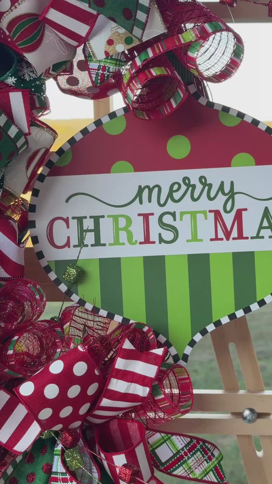 A joyful burst of color and Christmas cheer! This handcrafted Candy Stripe Grapevine Wreathfeatures layers of designer ribbon, sparkling accents, and a festive “Merry Christmas” sign — perfect for welcoming guests this holiday season.